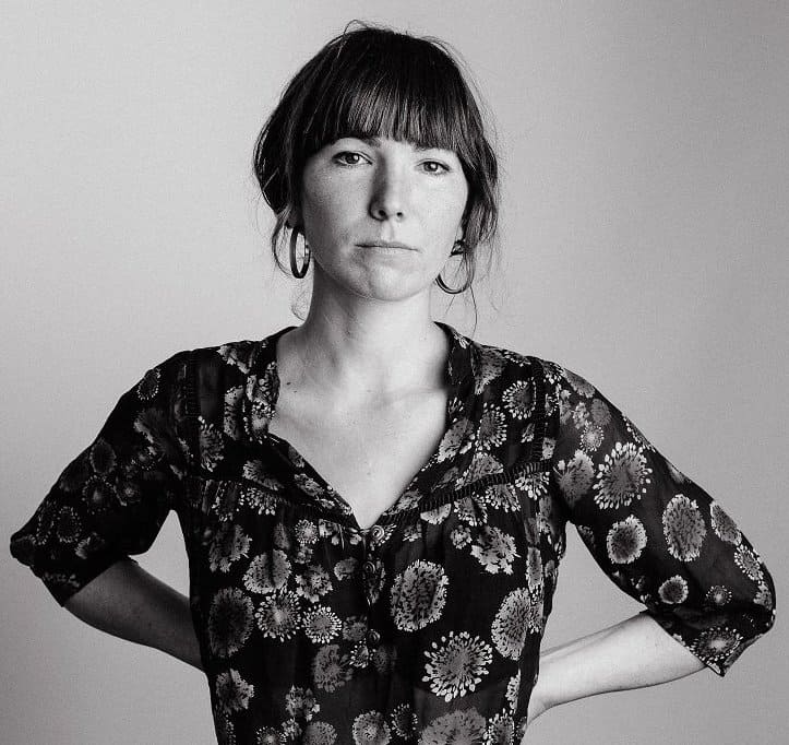Anna Tivel, standing arms akimbo