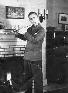 Young John Thomas playing flute