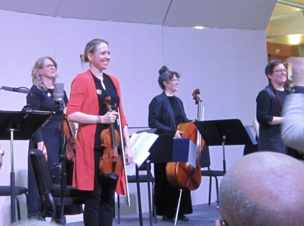 4 musicians bowing after carols for string quartet