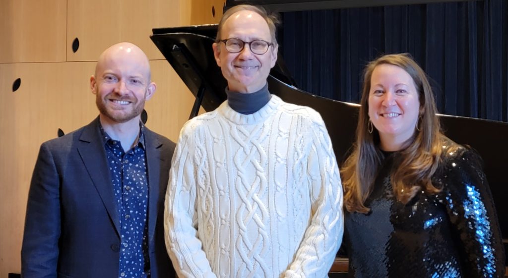 3 people in front of a piano